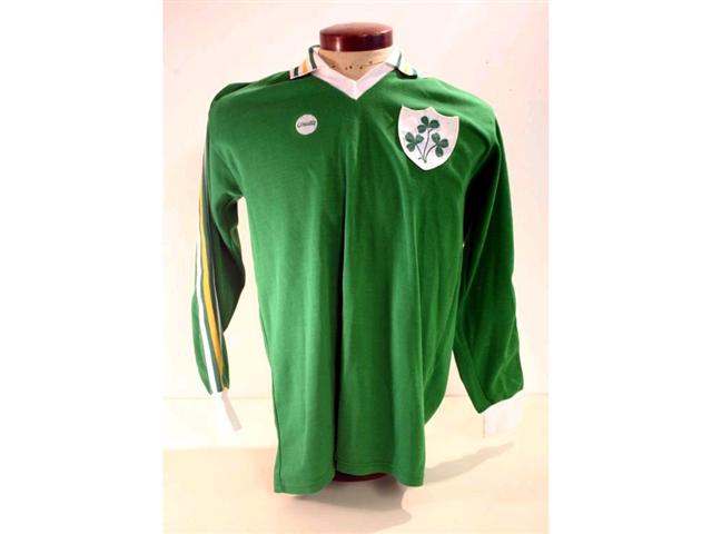319. Republic of Ireland International Shirt: A green with white & yellow trim V-neck shirt with embroidered Shamrock badge to front, No. 15 to rear plus exchange gift from the match, itinerary and programme. £200-250
