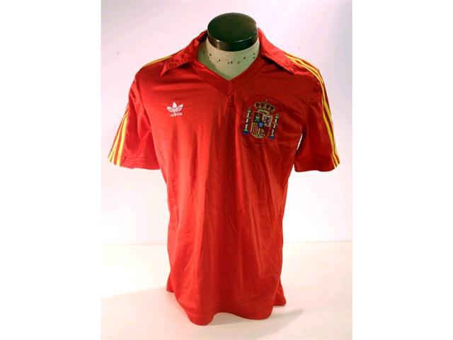 320. Spanish International Shirt: A red with yellow trim V-neck shirt with embroidered Spanish badge to front, No. 2 to rear plus match programme. £120-150