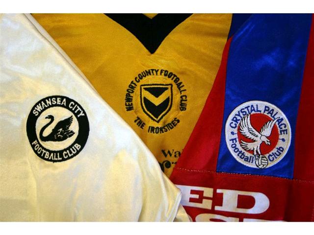 323. Shirts: An amber with black trim Newport County shirt, No. 13 to rear, a white with black trim Swansea City shirt, No. 11 to rear & a blue & red Crystal Palace shirt, No. 7 to rear. (3). £75-100